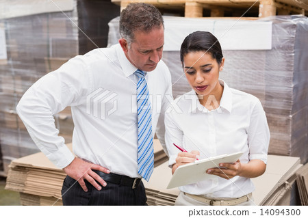 Warehouse manager and her boss working together 14094300