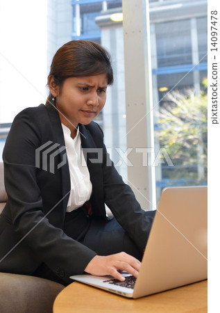 Young indian businesswoman is using laptop computer. 14097478