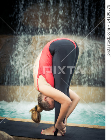 Practicing yoga. Padahastasana Practicing yoga. Padahastasana 14100379