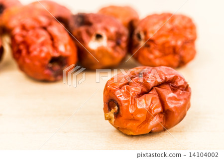 Close up and selective focus on the dried Chinese Red Dates at the foreground 14104002