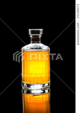 Whiskey on the rocks, with a whiskey bottle in dark background 14106072