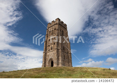 Tourists exploring the ruins of St. Michael's Tower at the top of glastonbury tor in somerest englan Tourists exploring the ruins of St. Michael's Tower at the top of glastonbury tor in somerest englan 14106472
