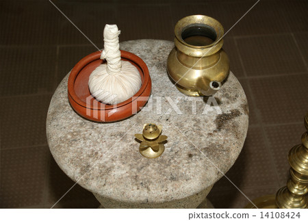 Candles, a bag with herb butter and a pitcher for Ayurveda, Kerala, South India 14108424