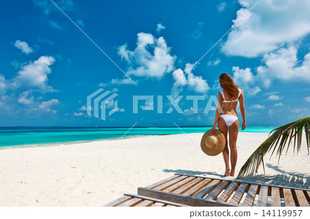 Woman in bikini on a beach at Maldives 14119957
