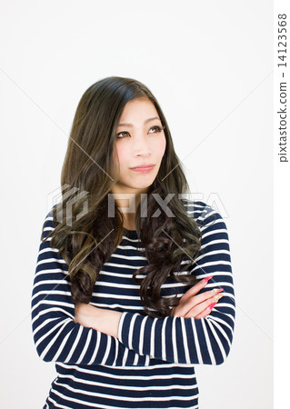 A young woman with arms crossed with oblique upper eyes 14123568