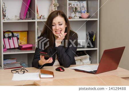 Office worker in horror looking at phone 14129488
