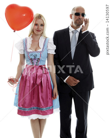 Woman in Dirndl with Bodyguard 14130597