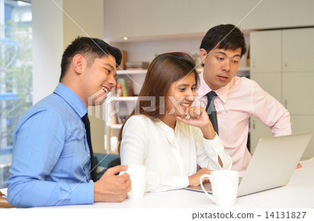 Three Business Colleagues Discussing Document in Office 14131827