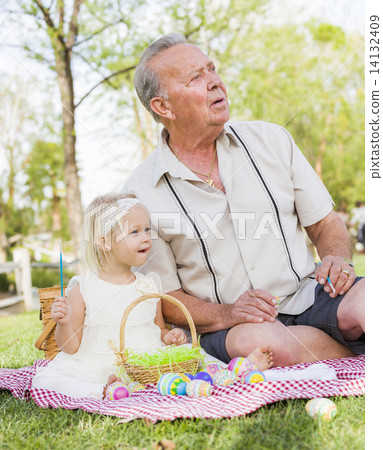Grandfather and Granddaughter Coloring Easter Eggs on Blanket At 14132409