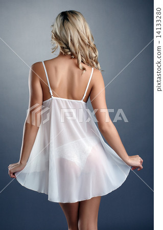 Rear view of slim tanned blonde in negligee 14133280