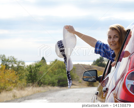 Young happy woman holds sun hat Young happy woman holds sun hat 14138879