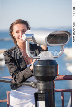 Woman with binoculars near seaport 14143019