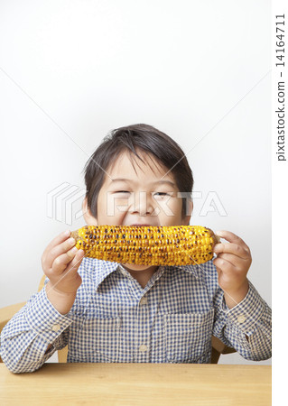 A child eating corn 14164711