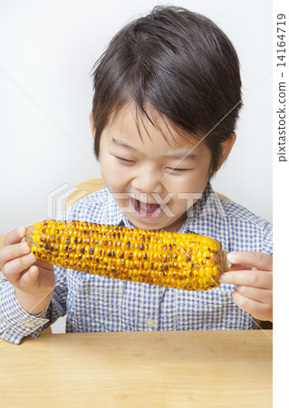 A child eating corn A child eating corn 14164719