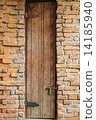 Tall door on the brick wall 14185940