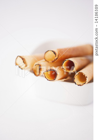 A handful of egg rolls placed in a bowl for guests. A handful of egg rolls placed in a bowl for guests. 14186389