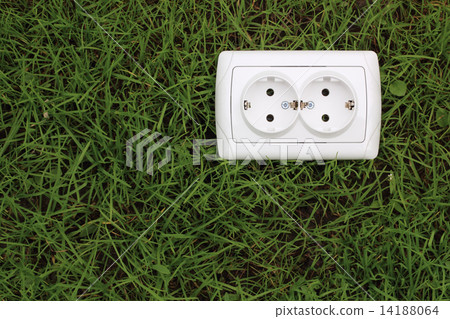 electric power receptacle on a green grass background 14188064