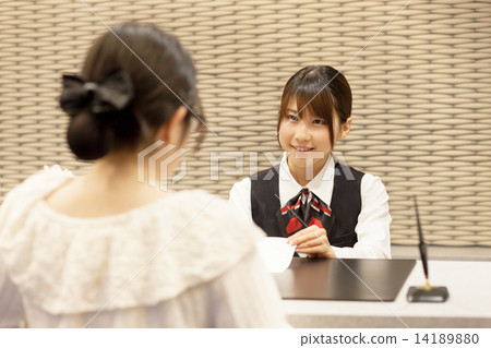 A cute girl in the front desk of the hotel A cute girl in the front desk of the hotel 14189880