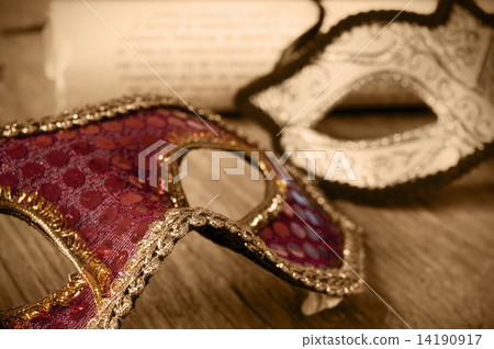 masks and roll on a wooden surface in sepia toning 14190917