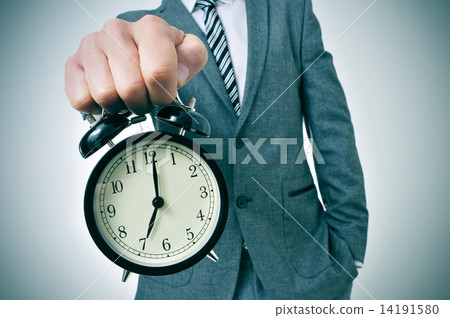 young man with an alarm clock young man with an alarm clock 14191580
