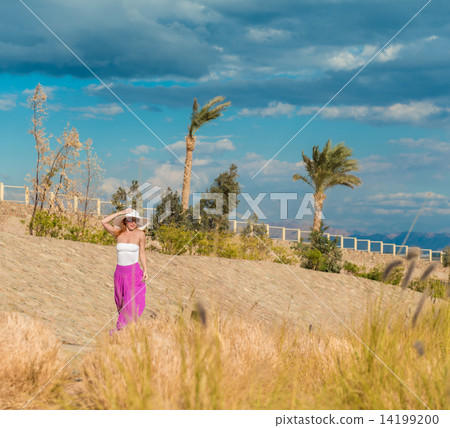 Beautiful woman wearing hat and pink skirt 14199200