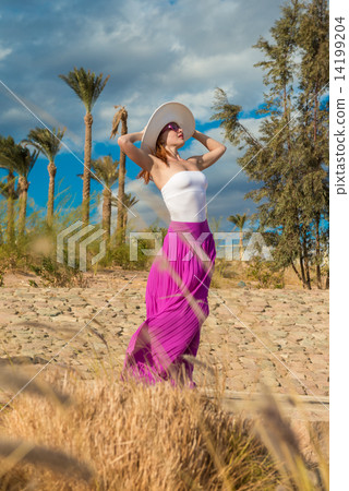 Beautiful woman wearing hat and pink skirt 14199204
