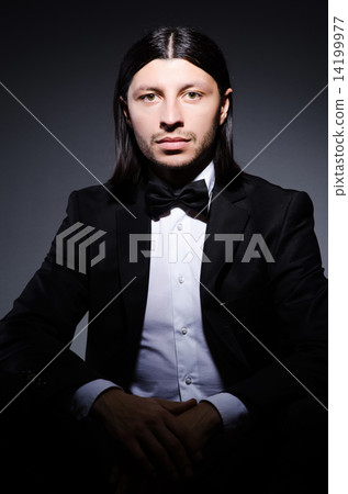 Handsome man against the dark background Handsome man against the dark background 14199977