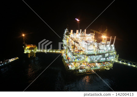 oil and gas construction in night view. View from helicopter night flight. Oil and gas platform in o oil and gas construction in night view. View from helicopter night flight. Oil and gas platform in o 14200413
