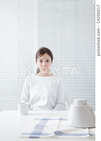 A woman relaxing at the dining room 14200817