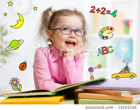 Funny smart kid in glasses reading book in kindergarten 14203588