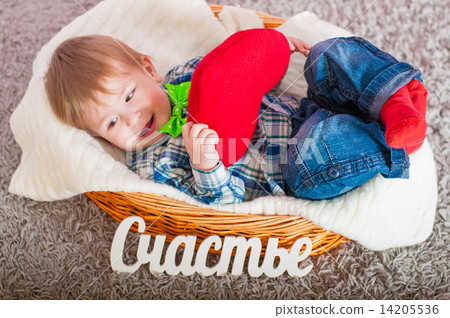 Child in the bow tie is in the basket with a blanket Child in the bow tie is in the basket with a blanket 14205536