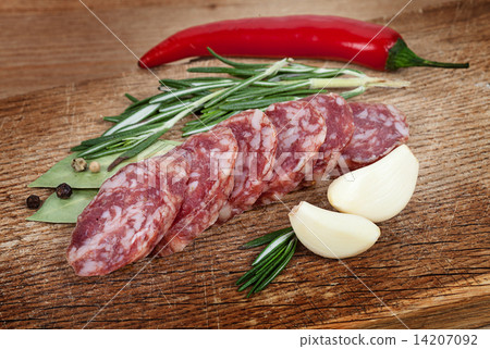 Sliced sausage spices and garlic on a board. Sliced sausage spices and garlic on a board. 14207092