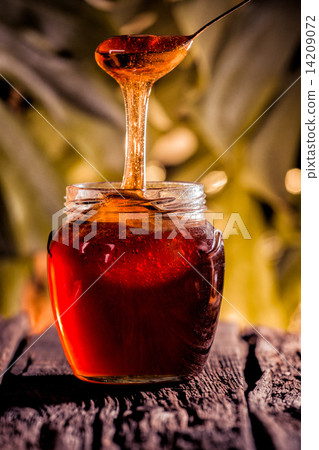 Honey drip in jar on the table 14209072