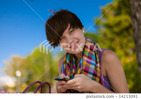 Young beautiful woman writes an SMS 14213091