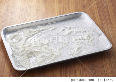 Flour in metal tray on wooden table Flour in metal tray on wooden table 14217679