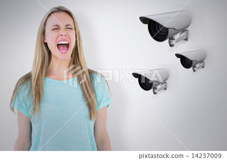 Composite image of furious blonde standing and screaming 14237009