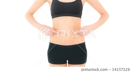 Closeup mid section of a fit woman with hands on stomach 14237228