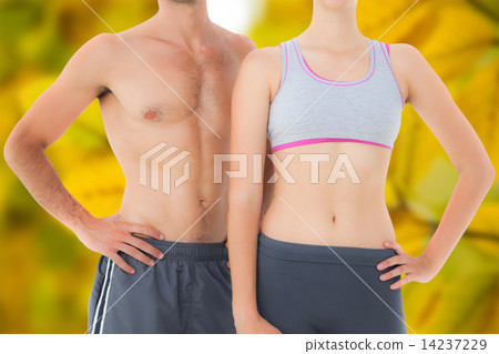 Composite image of mid section of a fit young couple Composite image of mid section of a fit young couple 14237229