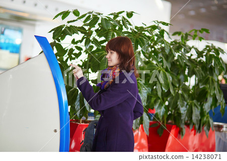 Passenger at the airport, doing self check-in Passenger at the airport, doing self check-in 14238071