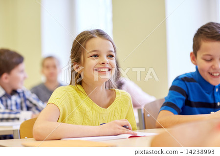 Stock Photo: group of school kids writing test in classroom