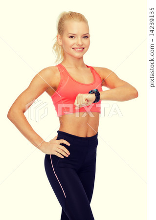 smiling woman with heart rate monitor on hand 14239135