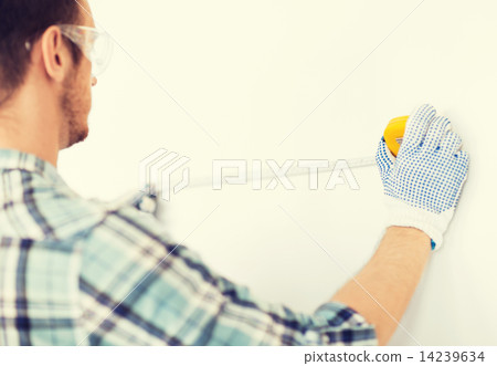 architect measuring wall with flexible ruler architect measuring wall with flexible ruler 14239634