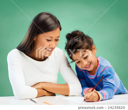 Stock Photo: happy teacher and little school girl drawing