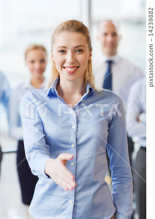 smiling businesswoman making handshake in office smiling businesswoman making handshake in office 14239882