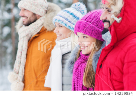 group of smiling men and women in winter forest group of smiling men and women in winter forest 14239884