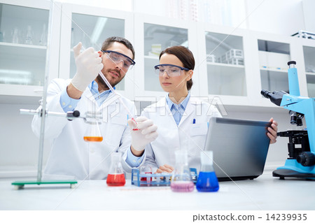 young scientists making test or research in lab young scientists making test or research in lab 14239935