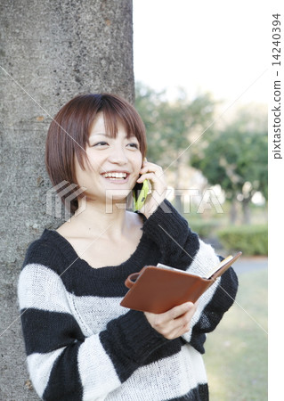 Young woman talking on a smartphone Young woman talking on a smartphone 14240394