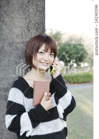 Young woman talking on a smartphone Young woman talking on a smartphone 14240396