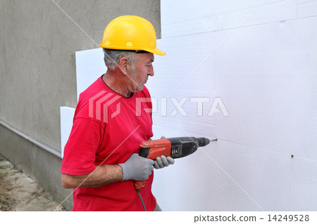 Construction site, styrofoam insulation drill for anchor 14249528