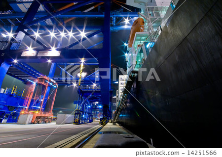 Container Cargo operation in busy Port Terminal with Ship moored alongside by night 14251566